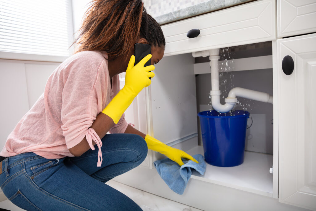 Plumbing emergency using bucket to contain water